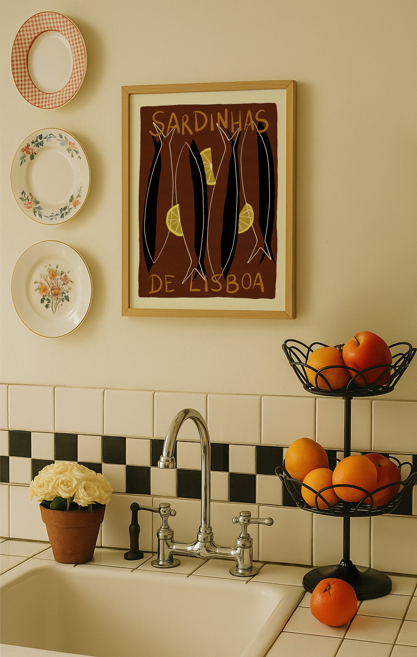 Kitchen with a sink, decorative plates, and a framed picture on the wall.