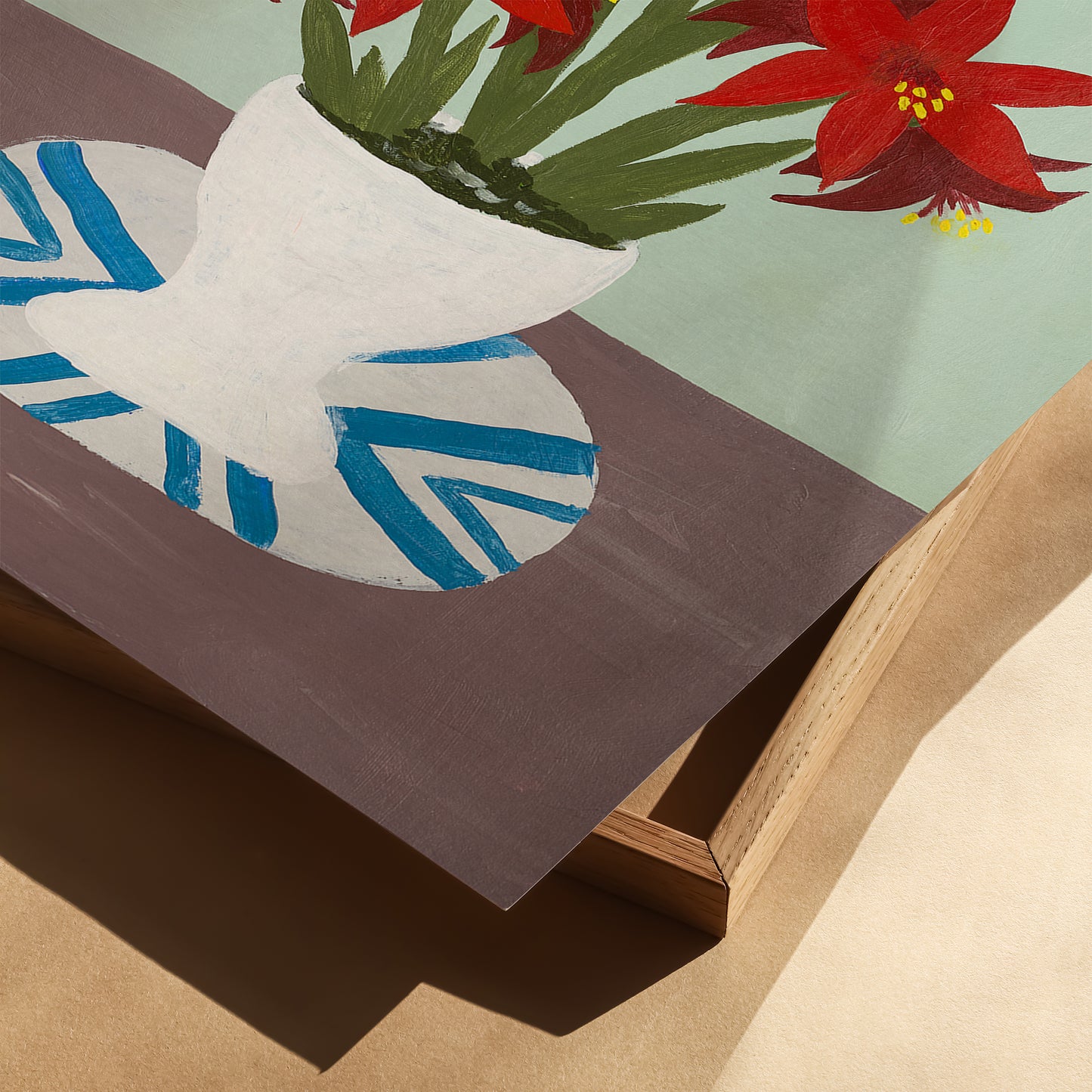 Close-up of red amaryllis still-life art print showing white vase and blue patterned plate. Botanical wall art with painterly texture and vintage style.