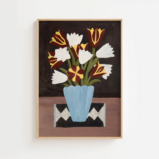 Still life painting of red and white tulips with yellow accents in a blue vase on a patterned cloth. Modern floral wall art print in mid-century and boho style for living room or kitchen decor.